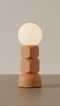 Soft terracotta accent lamp, Default angle is a slightly elevated 3/4 view that flatters geometric shapes and reveals...